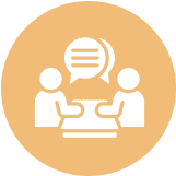 Two people talking at a table icon.